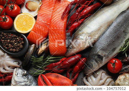 Fresh fish and different seafood on table, flat lay 104757012