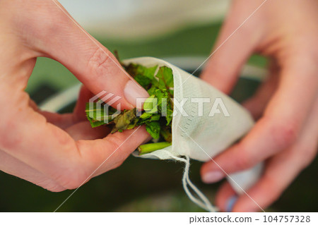 The process of packing the collection of tea herbs in convenient portioned bags. 104757328