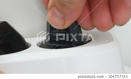 Plugging a socket plug into a double extension cord Plugging a socket plug into a double extension cord 104757351