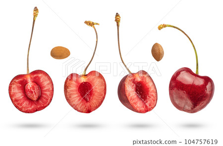 Halves of cherries on a white isolated background. Pitted cherry halves hanging or falling from above casting a shadow close-up on a white background. Halves of cherries on a white isolated background. Pitted cherry halves hanging or falling from above casting a shadow close-up on a white background. 104757619