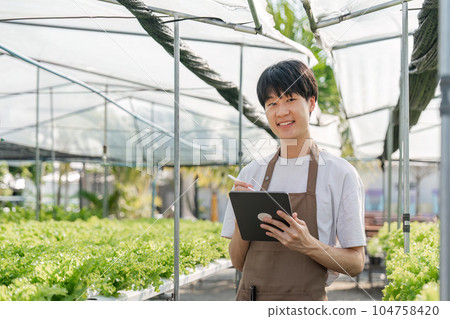 Farmer plantation checking quality by tablet agriculture modern technology Concept. Smart farming, using modern technologies in agriculture Farmer plantation checking quality by tablet agriculture modern technology Concept. Smart farming, using modern technologies in agriculture 104758420