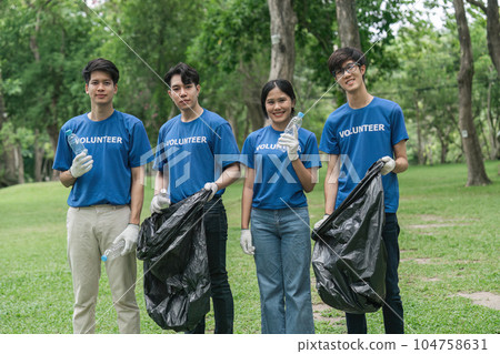 Team volunteers collecting garbage in public park. Environmental protection Concept 104758631