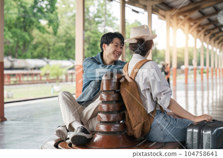 Asian couple chatting while waiting for upcoming train 104758641