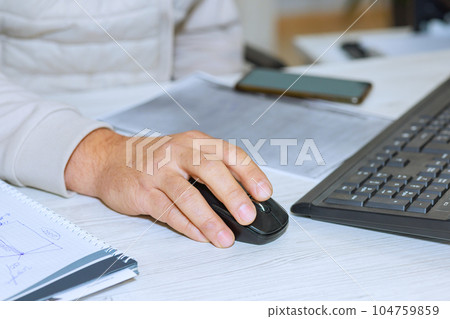 Organized desktop of businessman reflects his meticulous approach to his work on computer. 104759859