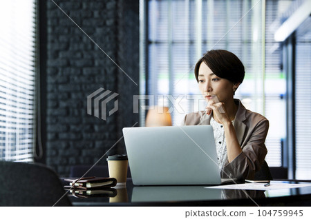 Female business computer serious thinking 104759945