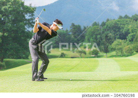 Golfer man making an iron shot on the golf course Golfer man making an iron shot on the golf course 104760198