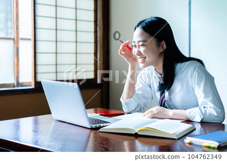 High school girl taking online classes at home 104762349