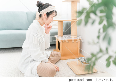 Owner asian woman changing cat water 104764019