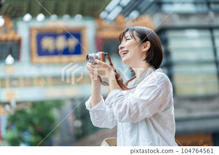 A woman holding a camera A woman traveling A woman sightseeing in Chinatown A woman holding a camera A woman traveling A woman sightseeing in Chinatown 104764561