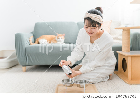 Owner asian woman feeding cat Owner asian woman feeding cat 104765705