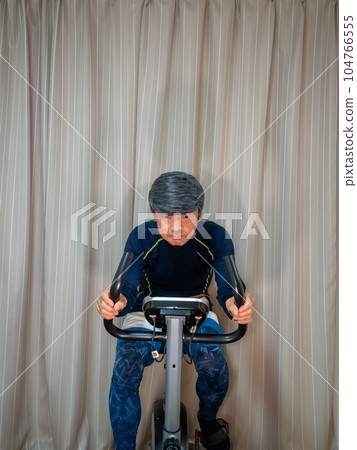 Senior man training on a fitness bike (exercise bike) Senior man training on a fitness bike (exercise bike) 104766555