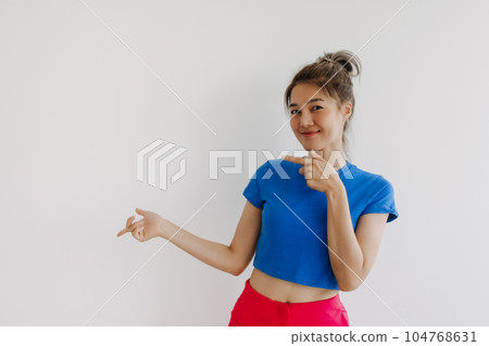 Happy woman point and present on empty space isolated on white. 104768631
