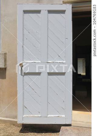 White door in stone house White door in stone house 104769183