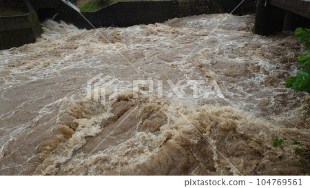 Heavy rain caused by a linear rain belt causes rivers to exceed flood warning water levels 104769561
