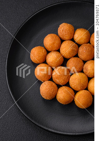 Delicious fried potato balls with breaded mozzarella, salt, spices and herbs Delicious fried potato balls with breaded mozzarella, salt, spices and herbs 104769871
