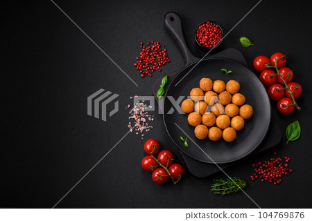Delicious fried potato balls with breaded mozzarella, salt, spices and herbs Delicious fried potato balls with breaded mozzarella, salt, spices and herbs 104769876