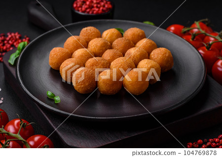 Delicious fried potato balls with breaded mozzarella, salt, spices and herbs Delicious fried potato balls with breaded mozzarella, salt, spices and herbs 104769878