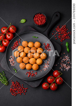 Delicious fried potato balls with breaded mozzarella, salt, spices and herbs Delicious fried potato balls with breaded mozzarella, salt, spices and herbs 104769890