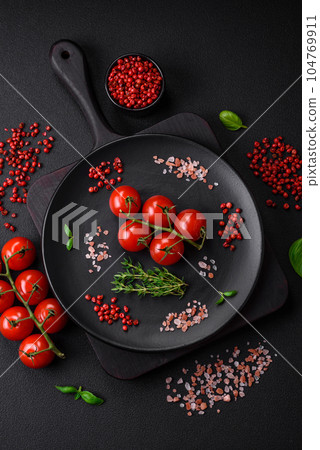 Ingredients for cooking cherry tomatoes, salt, spices and herbs 104769911