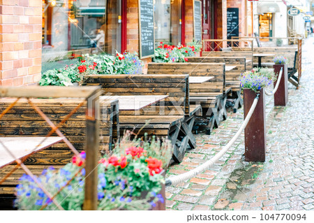 Terrace seats of a stylish restaurant decorated with cute flowers Terrace seats of a stylish restaurant decorated with cute flowers 104770094
