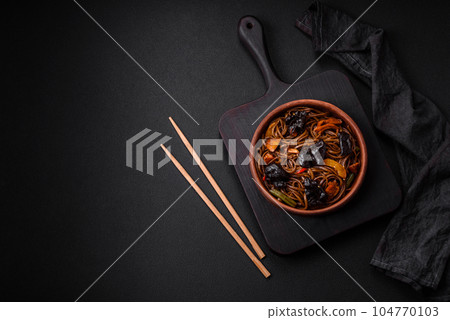 Delicious fresh buckwheat noodles or udon with mushrooms, peppers and other vegetables 104770103