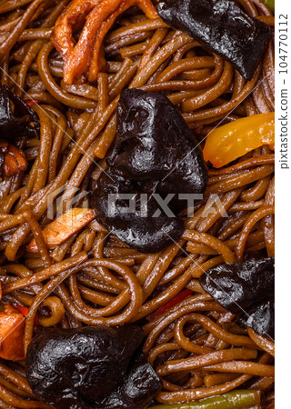 Delicious fresh buckwheat noodles or udon with mushrooms, peppers and other vegetables Delicious fresh buckwheat noodles or udon with mushrooms, peppers and other vegetables 104770112