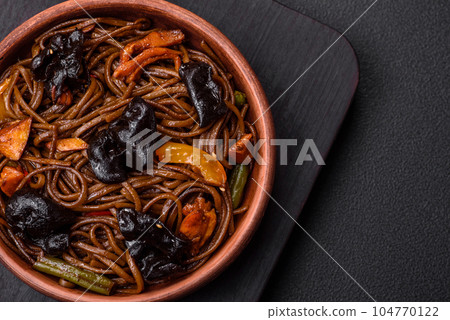 Delicious fresh buckwheat noodles or udon with mushrooms, peppers and other vegetables 104770122