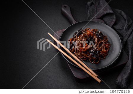 Delicious fresh buckwheat noodles or udon with mushrooms, peppers and other vegetables Delicious fresh buckwheat noodles or udon with mushrooms, peppers and other vegetables 104770136