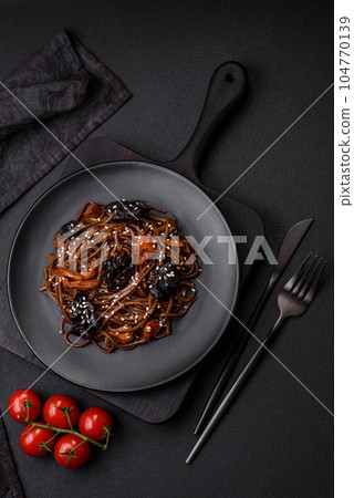 Delicious fresh buckwheat noodles or udon with mushrooms, peppers and other vegetables Delicious fresh buckwheat noodles or udon with mushrooms, peppers and other vegetables 104770139