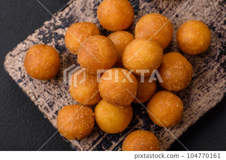 Delicious fried potato balls with breaded mozzarella, salt, spices and herbs Delicious fried potato balls with breaded mozzarella, salt, spices and herbs 104770161