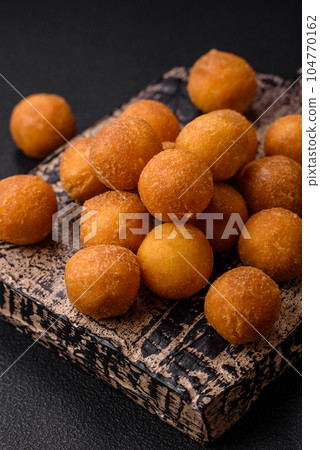 Delicious fried potato balls with breaded mozzarella, salt, spices and herbs 104770162