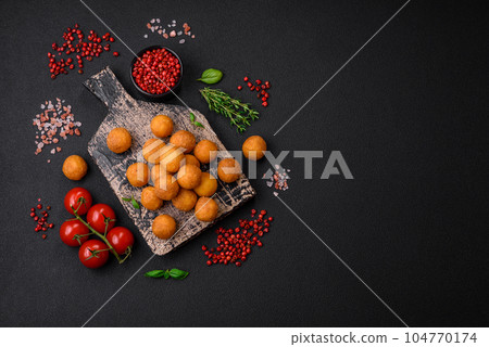 Delicious fried potato balls with breaded mozzarella, salt, spices and herbs Delicious fried potato balls with breaded mozzarella, salt, spices and herbs 104770174