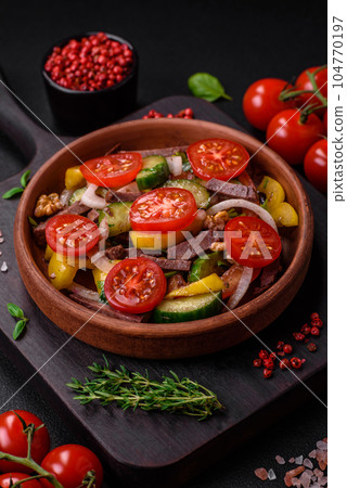 Delicious fresh salad with beef slices, cherry tomatoes, sweet peppers Delicious fresh salad with beef slices, cherry tomatoes, sweet peppers 104770197