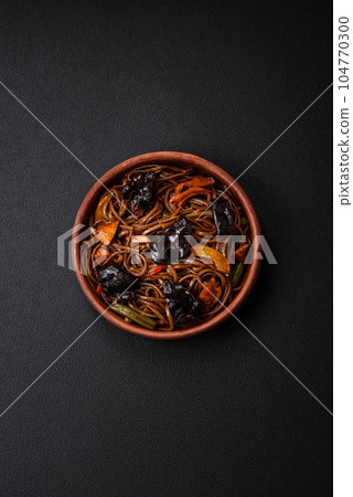 Delicious fresh buckwheat noodles or udon with mushrooms, peppers and other vegetables 104770300