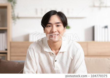 Asian handsome man standing cross arm looking at camera smile at home.Happy young smart businessman smile and confidence.Positive and good moment of asian male worker smile with wellness life Asian handsome man standing cross arm looking at camera smile at home.Happy young smart businessman smile and confidence.Positive and good moment of asian male worker smile with wellness life 104770375