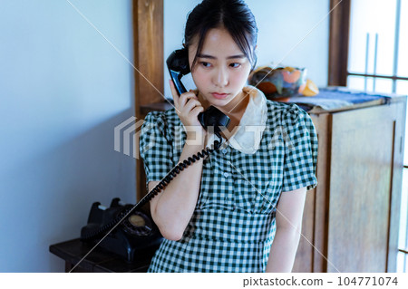 young woman using black phone young woman using black phone 104771074