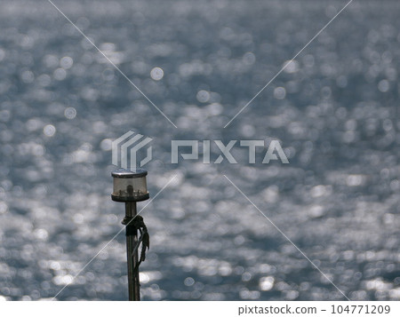 Lighting fixtures on the ship and glitter on the surface of the sea Lighting fixtures on the ship and glitter on the surface of the sea 104771209