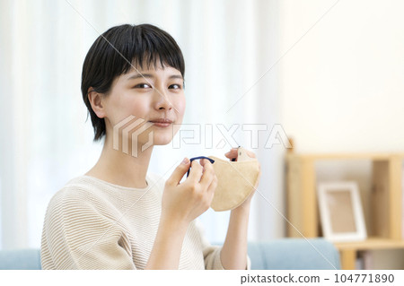 Young woman removing the mask Young woman removing the mask 104771890