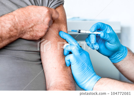 Elderly Man in Face Mask getting Covid Vaccine. Doctor giving Injection to senior Man at Hospital. Virus, COVID-2019, Flu protection. Vaccination of old Patient in Clinic during Coronavirus pandemic. Elderly Man in Face Mask getting Covid Vaccine. Doctor giving Injection to senior Man at Hospital. Virus, COVID-2019, Flu protection. Vaccination of old Patient in Clinic during Coronavirus pandemic. 104772081