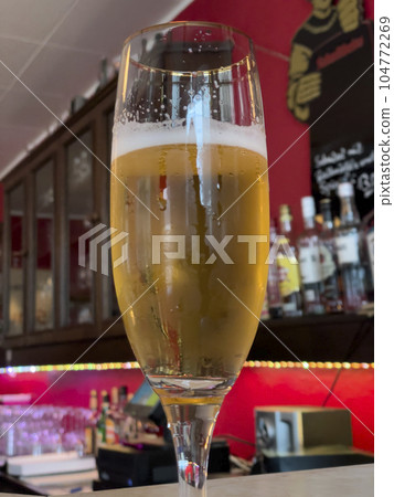 Stem beer glass with white foam. Selective focus Stem beer glass with white foam. Selective focus 104772269