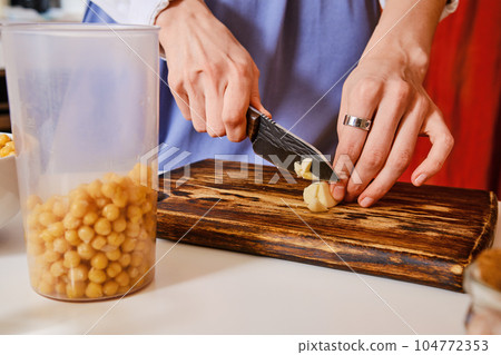 Closeup view of cutting garlic Closeup view of cutting garlic 104772353