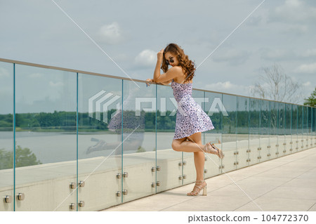 Joyful woman standing on observation deck 104772370