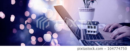 The concept of buying and selling real estate. A man with a model of a house on the background of the forex chart. 104774750