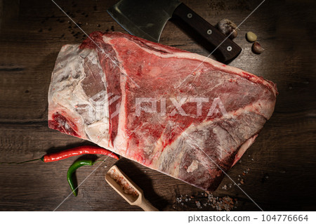 Organic machete or hanger butcher steak, near butcher knife with pink pepper and rosemary. Black background. Top view. side view 104776664