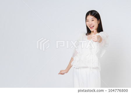 Young woman showing thumbs up isolated on white background. Young woman showing thumbs up isolated on white background. 104776800