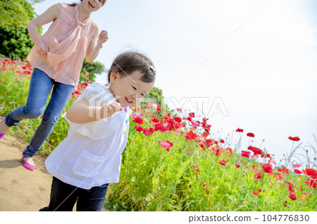 Mother and daughter playing in poppy hills Mother and daughter playing in poppy hills 104776830