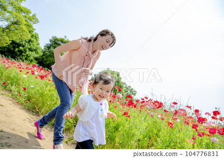 Mother and daughter playing in poppy hills Mother and daughter playing in poppy hills 104776831