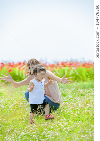 Mother and daughter playing in poppy hills 104776860