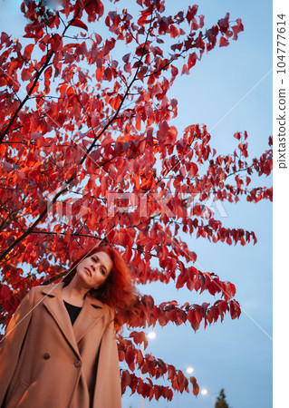 Portrait of beautiful red-haired woman merging with nature Portrait of beautiful red-haired woman merging with nature 104777614