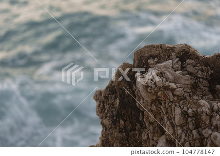 Detail shot of mediterranean rocks with turquoise sea Detail shot of mediterranean rocks with turquoise sea 104778147